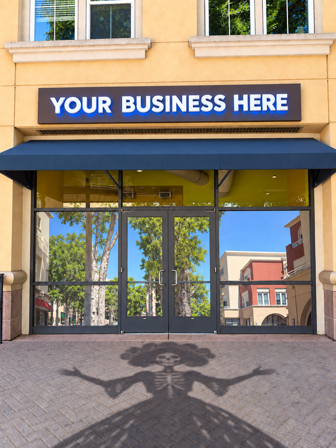 Available storefront with a Catrina shadow on the pavement